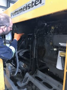Worker inspecting Putzmeister Equipment Oil System